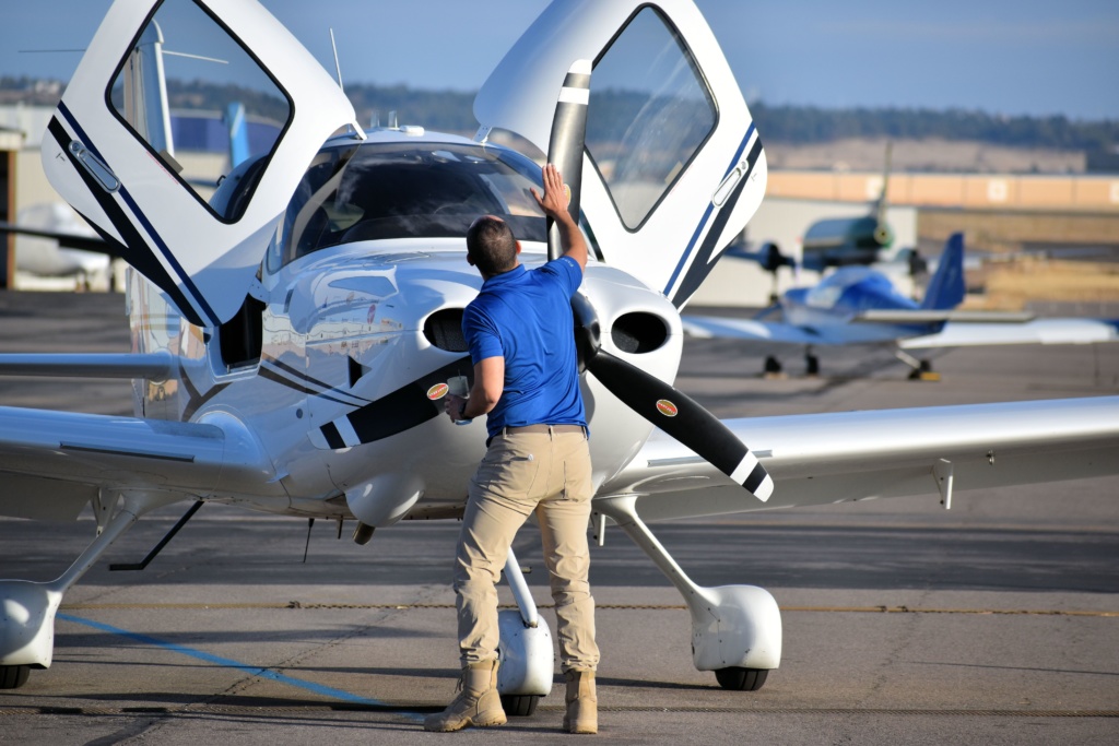 A flight instructor inspects a Hartzell propeller as he prepares to fly a Cirrus SR20.
